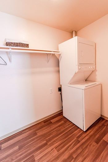 an empty room with a refrigerator and a washer and dryer